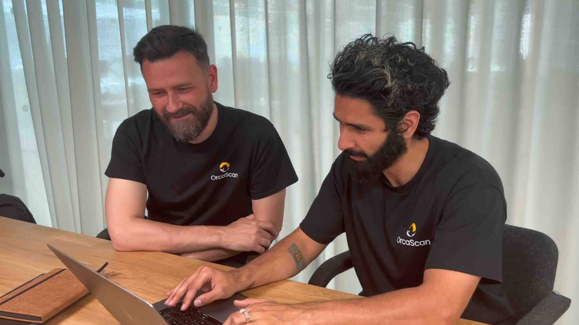 Orca Scan founder and CEO John Doherty (left) coding with Full Stack Engineer Milad Latif. 